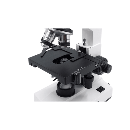Close-up of a microscope mechanical stage with spring slide holder, vernier scale and coaxial knobs