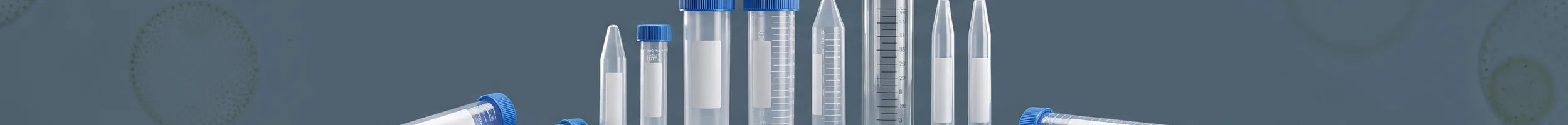 Laboratory centrifuge tubes in polypropylene and glass on a slate background