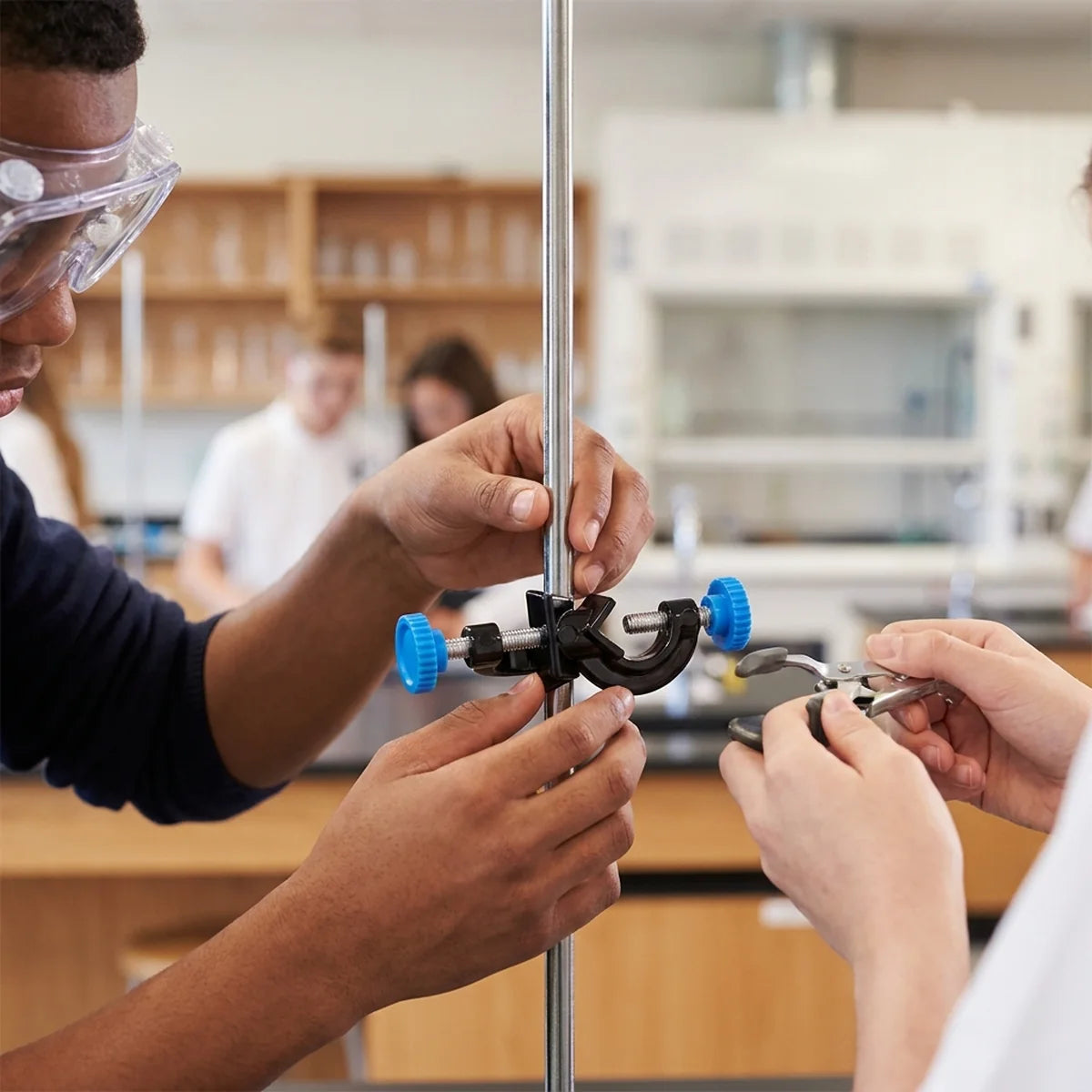 Students assembling retort stand clamp