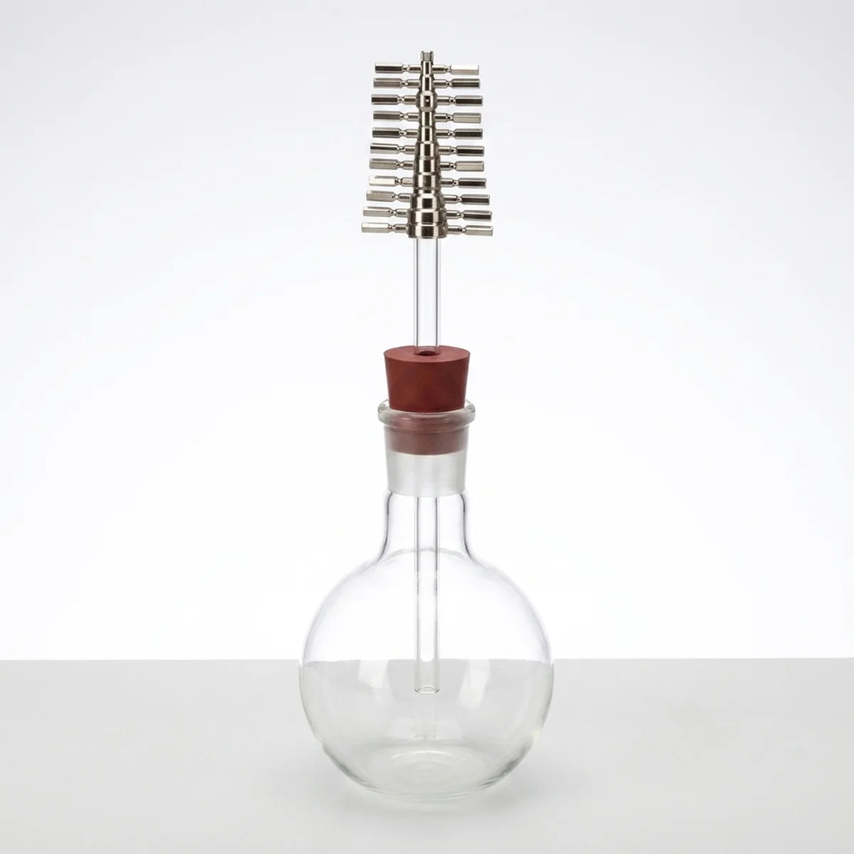 Bored stopper assembled onto flask
