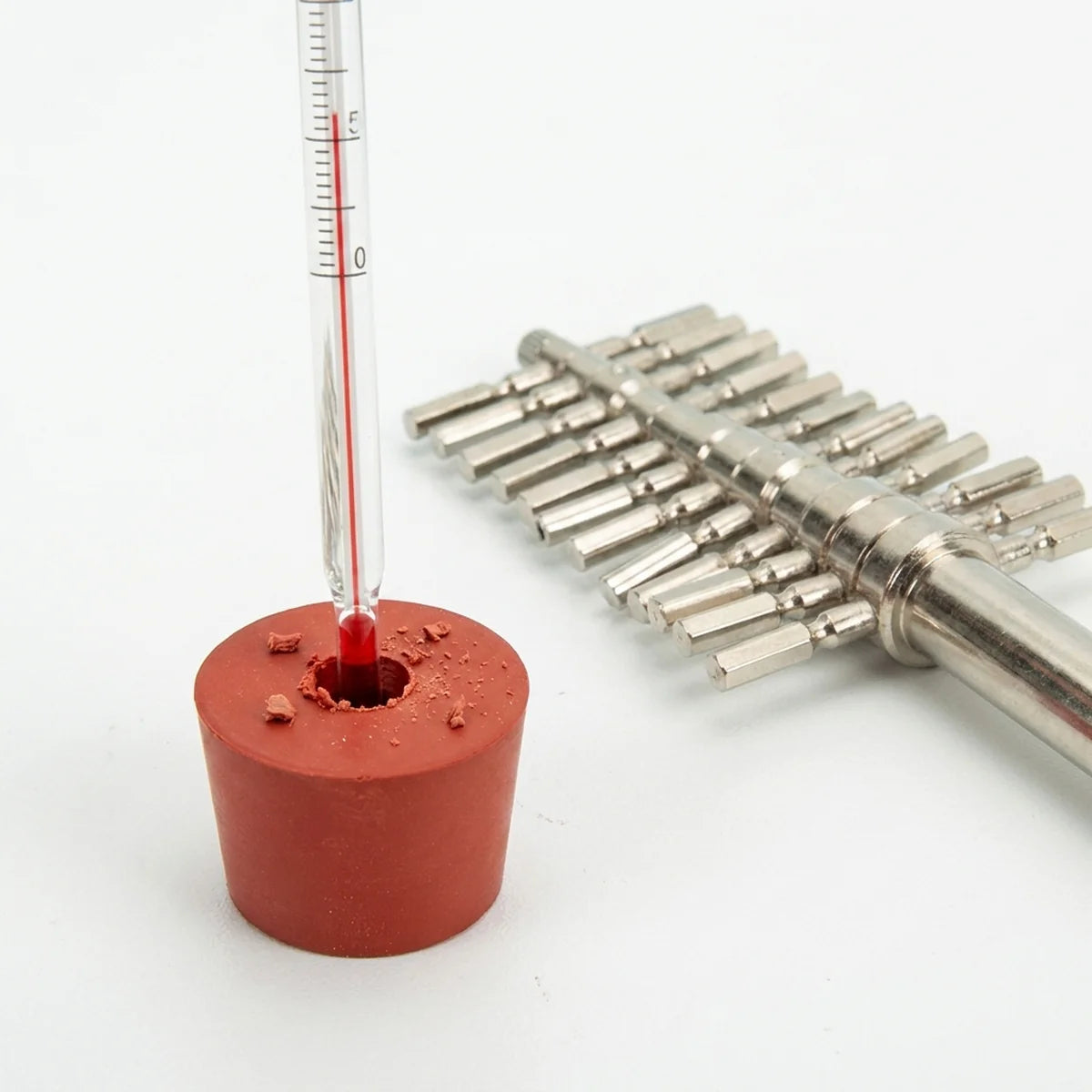 Thermometer inserted through bored stopper