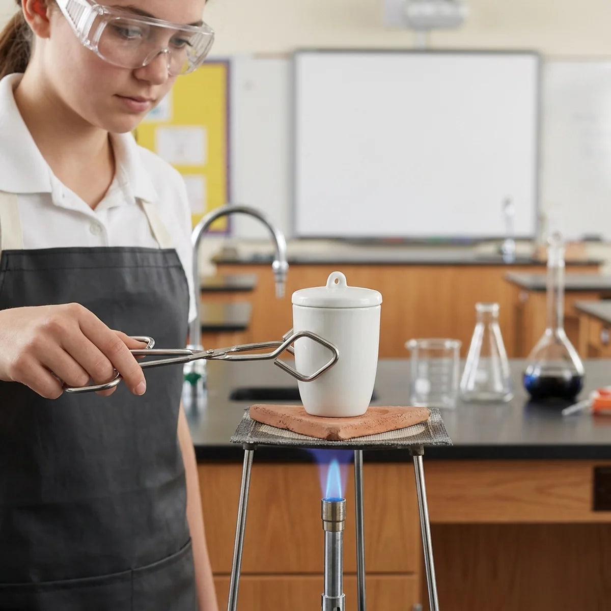 Student heating crucible in classroom