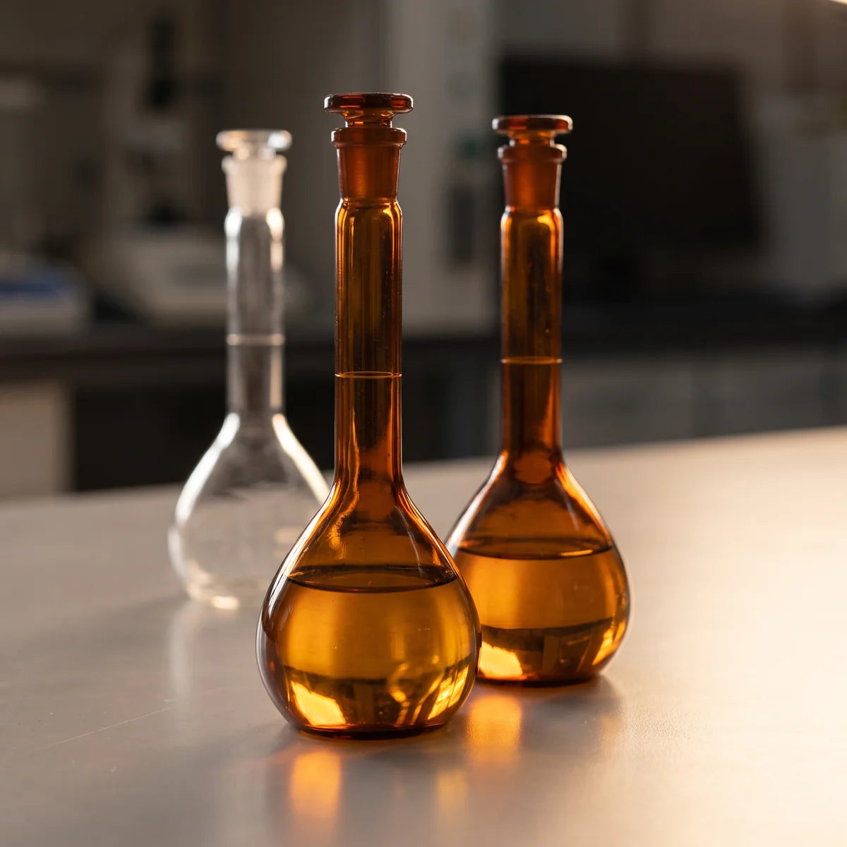 Amber glass volumetric flasks with ground glass stoppers for light sensitive solutions