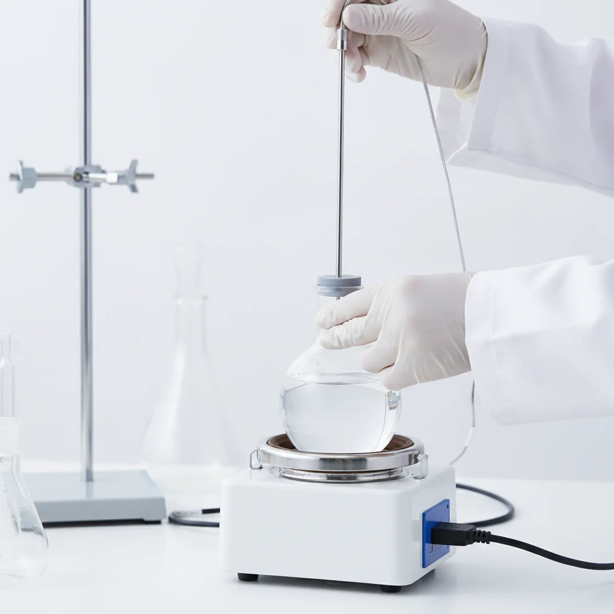 Inserting a temperature probe through a septum into a flask