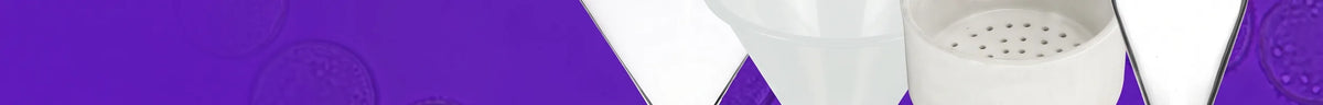 Clear glass filter funnel, white plastic funnel, porcelain Buchner funnel and glass separating funnel on a violet background