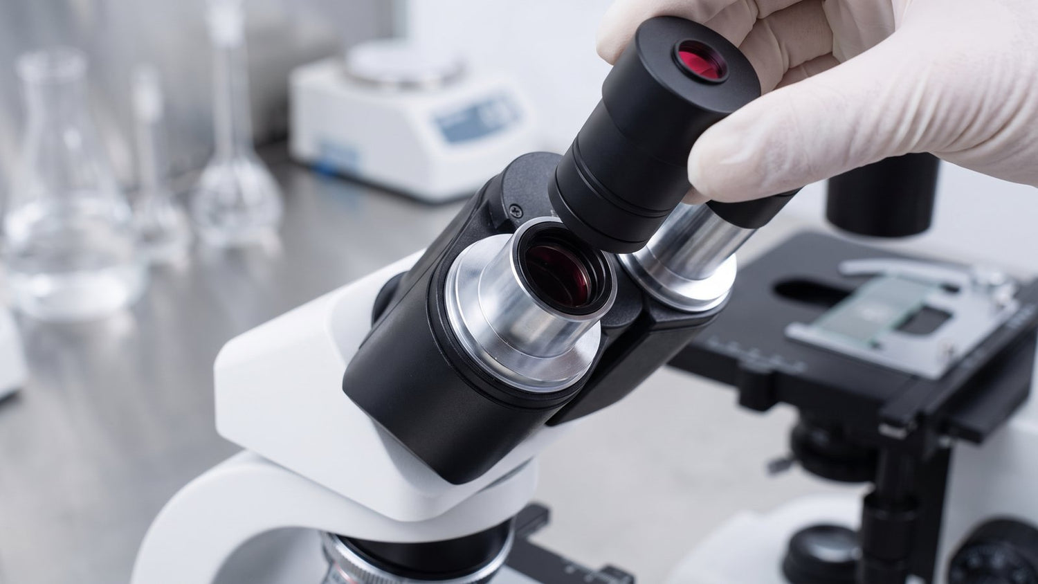 Eyepiece camera being fitted into the top port of a microscope