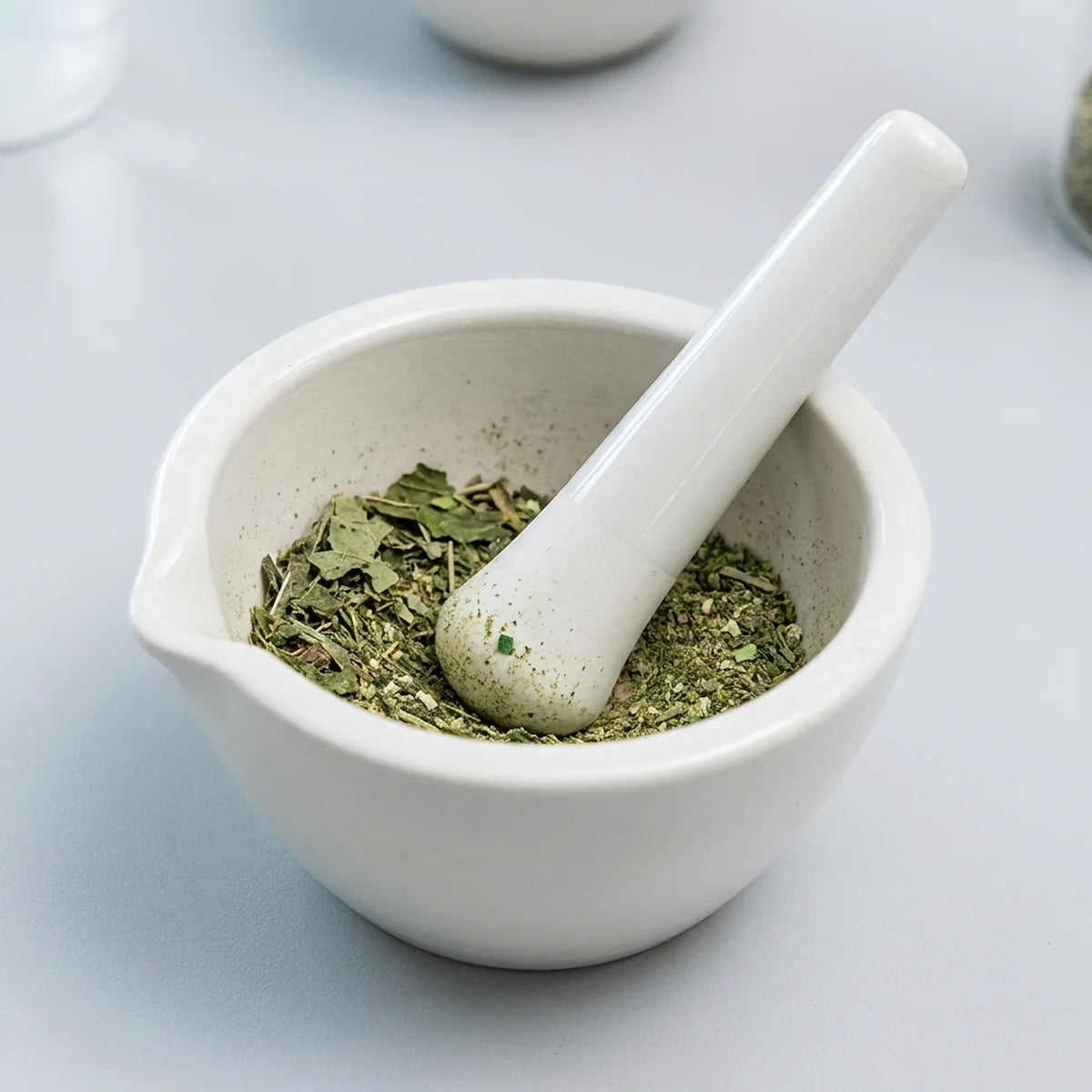 Grinding herbal material with mortar and pestle