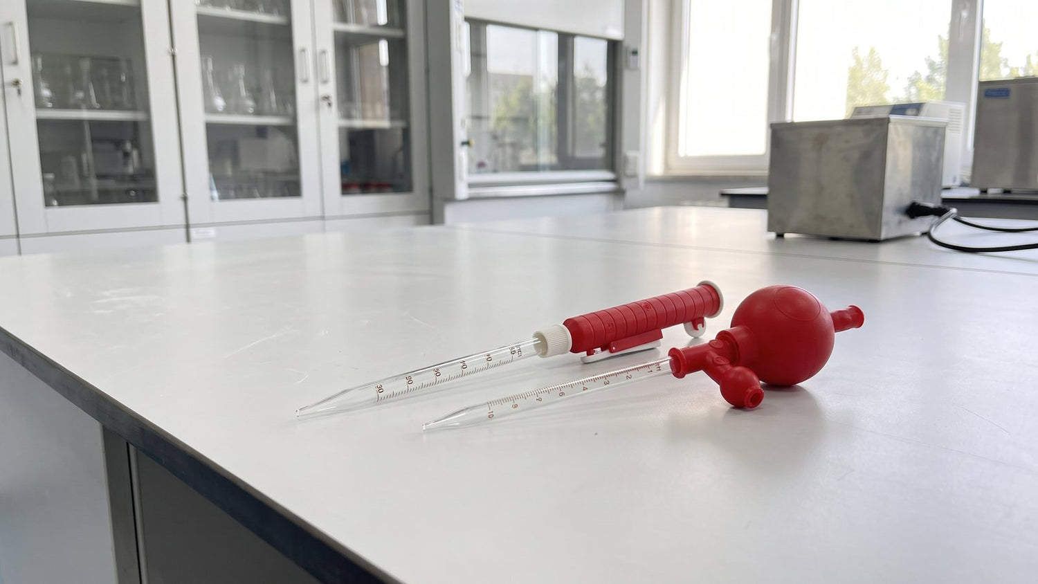 Pipette filler pump and safety bulb on a laboratory bench