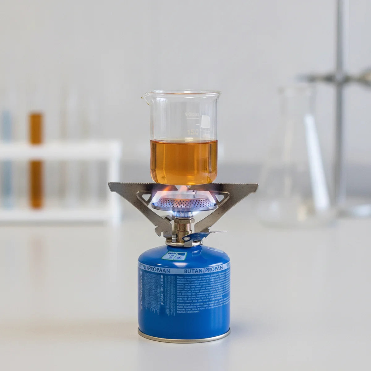Heating a beaker over a portable gas stove screwed onto a fuel cartridge
