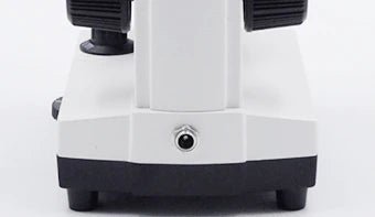 Back of a student microscope base showing the DC power adapter socket