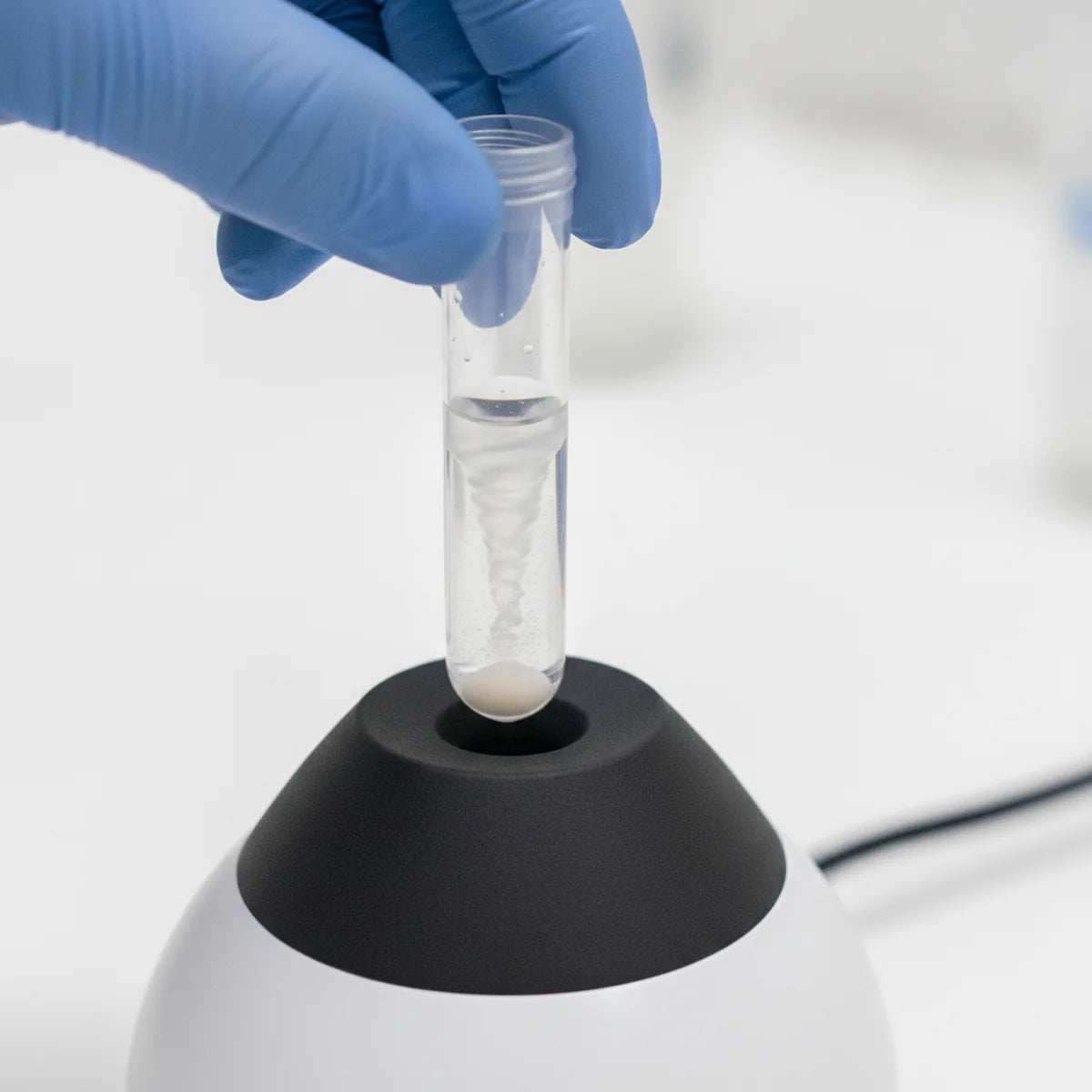 Resuspending a pellet in a microcentrifuge tube on a vortex mixer