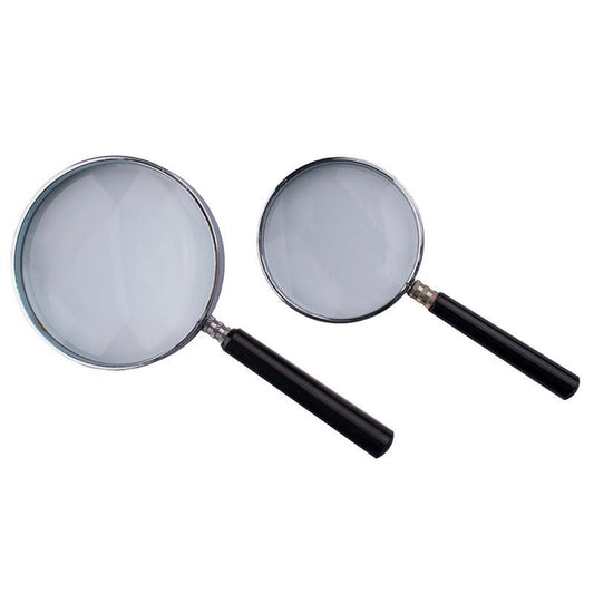 Reading magnifier with chrome plated metal frame and bakelite handle used for inspection and reading small print.